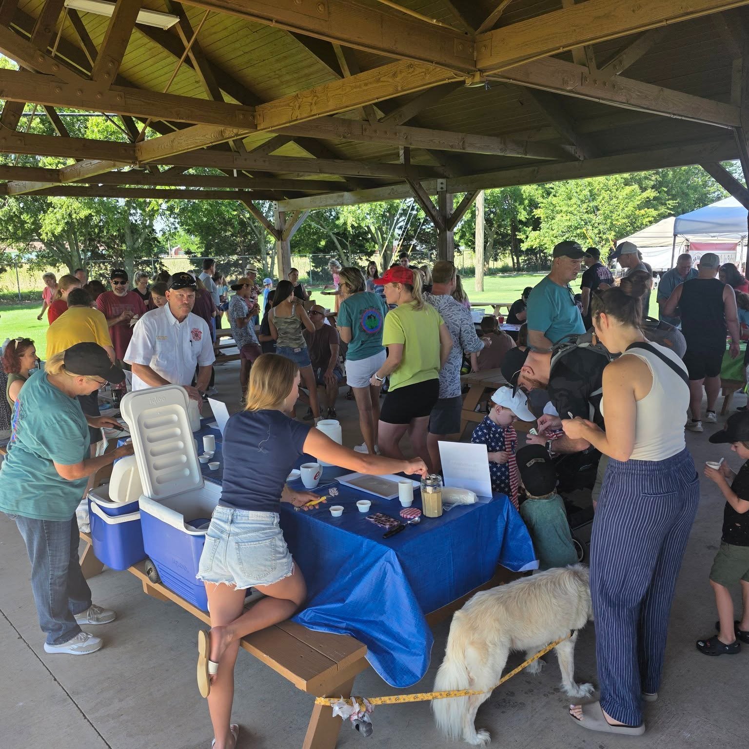 Shoppers mingling and sampling at Lucas Farmers Market