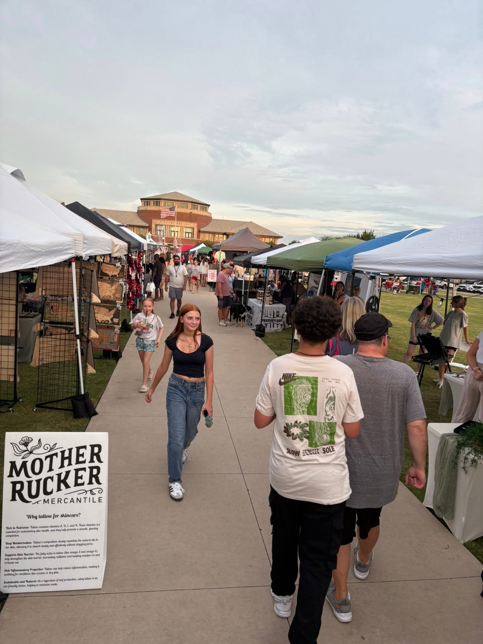 People shopping and walking at the busy market