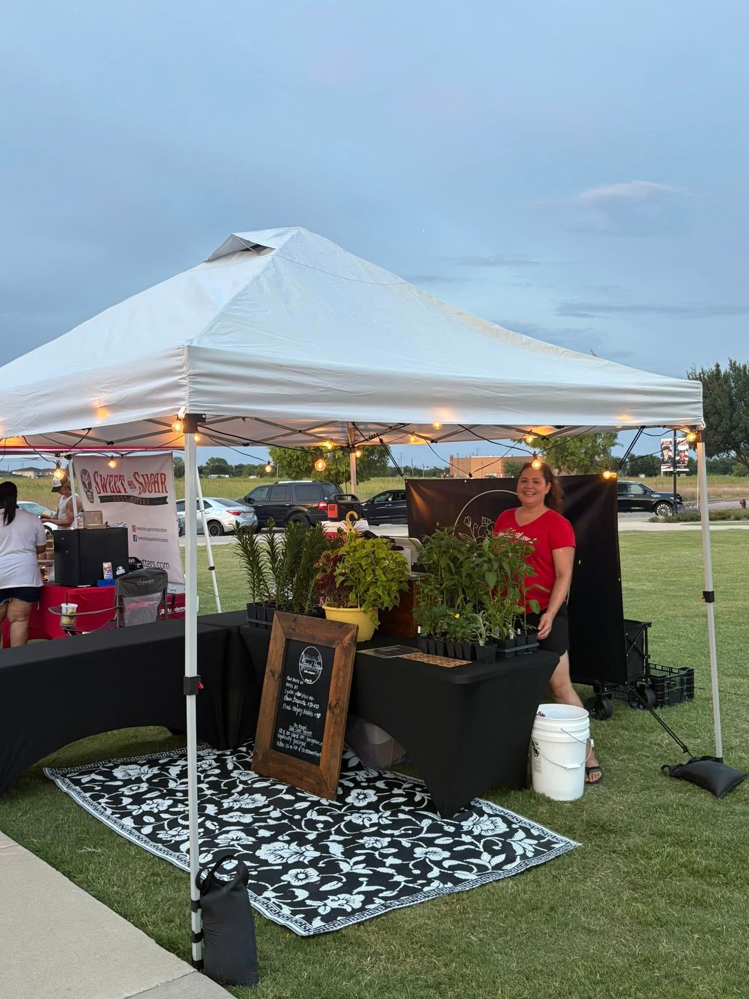 Smiling vendor inside a bustling market stall