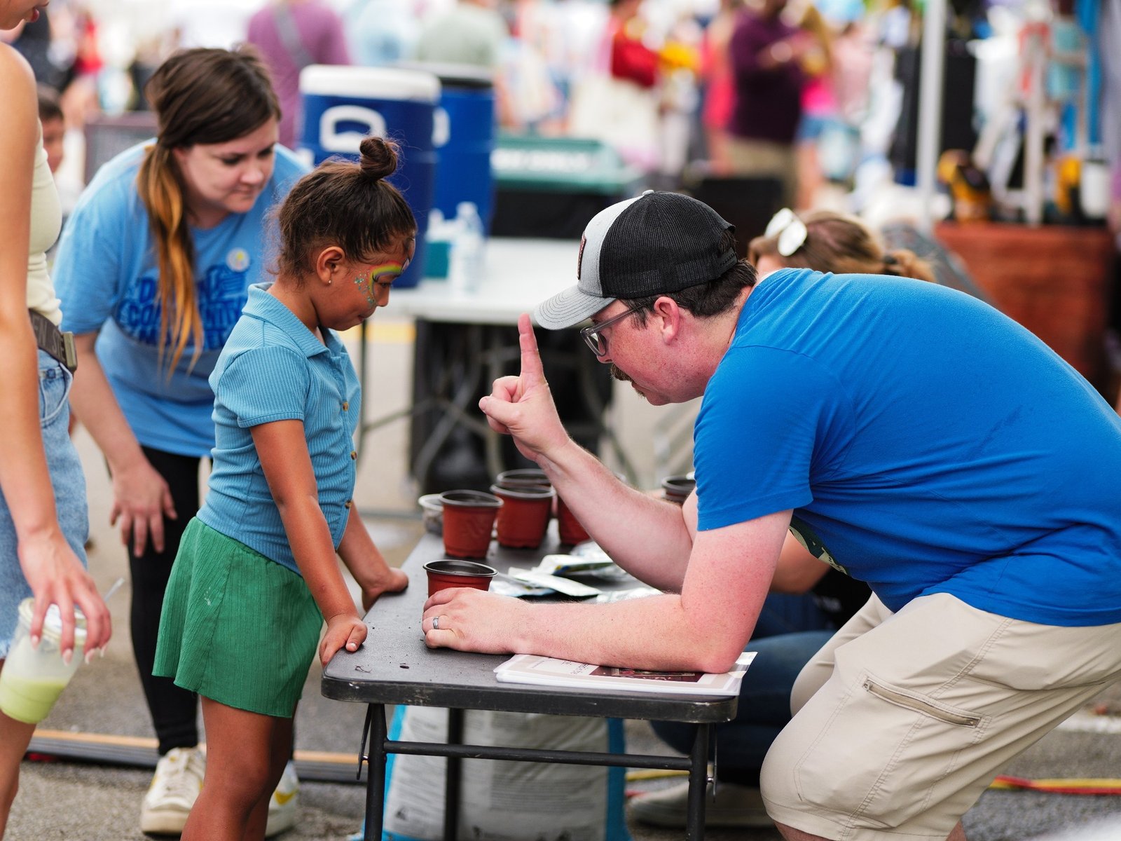 Allison teaching families about planting seeds at local Farmers Markets