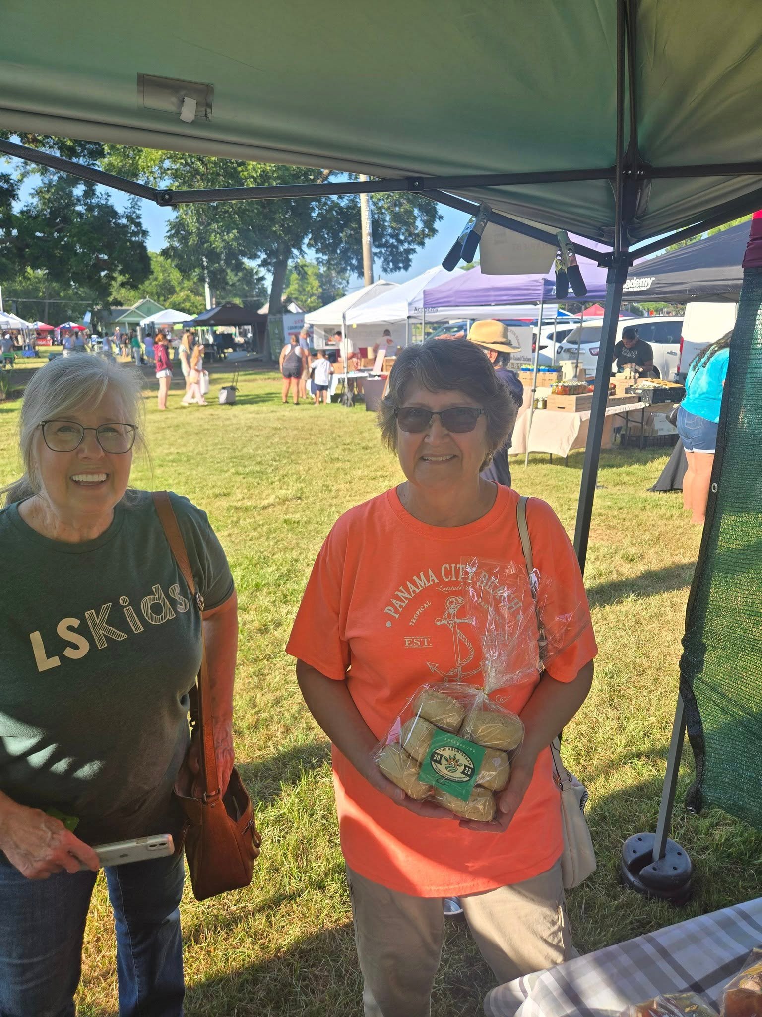 Happy Farmers Market Shoppers Choosing Holmestead Baked Goods